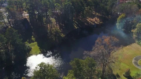Aerial drone fly over of small lake with a glimpse of sun. Stock Footage 170458378