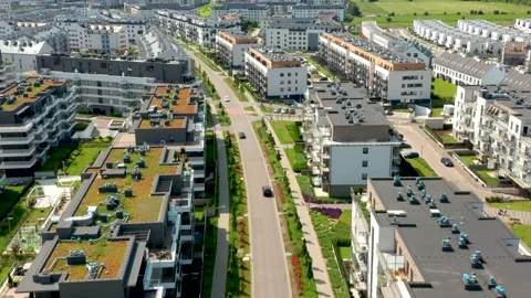 Aerial drone fly over suburban apartment buildings with street greenery and summ Stock Footage 312593261