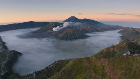 Aerial drone fly pass hill to reveal Bromo volcano, Java, Indonesia 動画素材 282437237