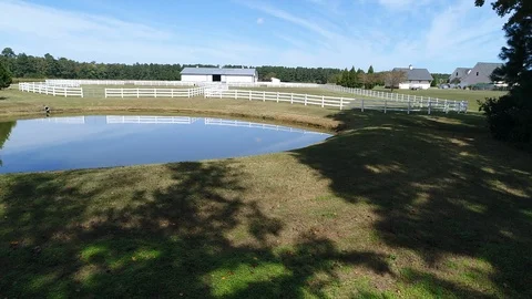 Aerial drone fly by of pond with reflection on water Stock Footage