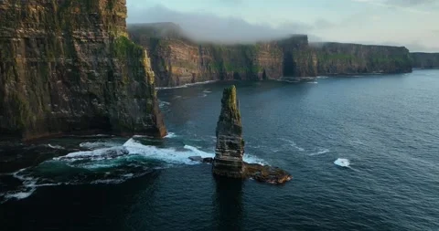 Aerial drone flyby of sea stack at Cliffs of Moher along Atlantic coastline Stock Footage 339503498