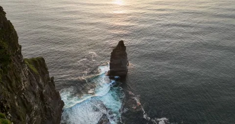 Aerial drone flyby of sea stack at sunset near Cliffs of Moher, Ireland Stock Footage 339504146