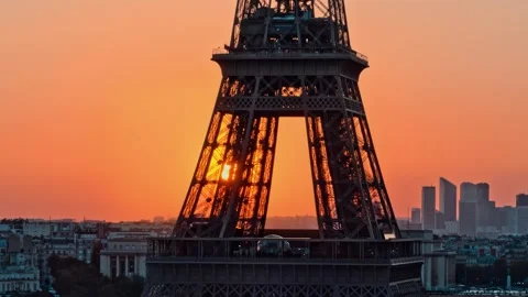 Aerial drone flying around the Eiffel tower during orange sunset or sunrise Video stock 303409951