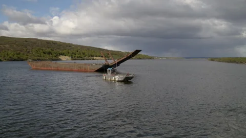 Aerial: Drone Flying Backward Shot Of Barge And Motorboats On Sea Against Cloudy Stock Footage 243223868