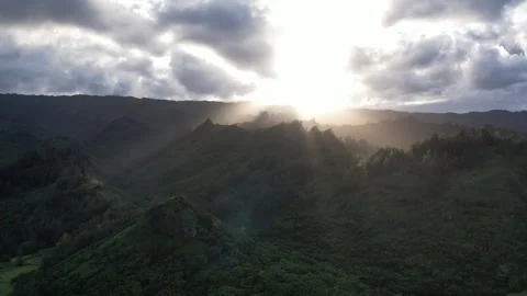 Aerial Drone Flying Backward Through Hawaiian Mountains with Cinematic Sunlight Stock Footage 318370766