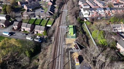 Aerial Drone Flying Backwards Over Electrified Railway Lines and Station Urb Stock Footage 330343188