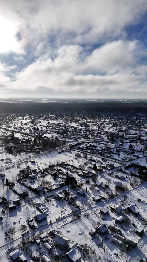Aerial Drone Flying Forward Above Snow Covered Rural Village in Northern Europe Stock Footage 338330352