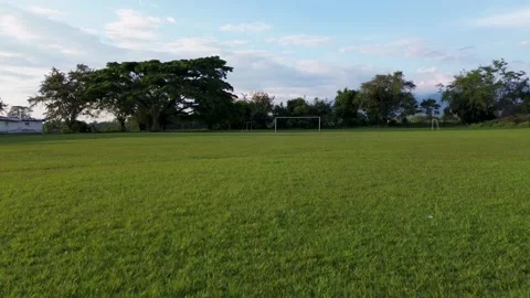 Aerial drone flying forward over a rural football field Stock Footage 307335417