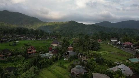 Aerial Drone Flying Forward Over Resort Area Over River and Green Field in Bali Stock Footage 327201562