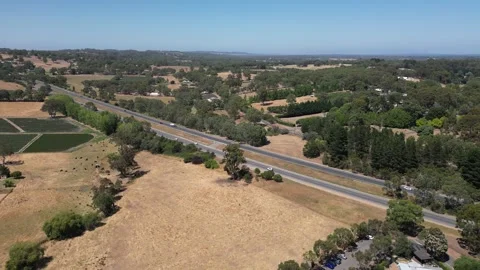 Aerial Drone Flying Forward Over Highway Through Dry Yellow Grassland Vídeo Stock 328088006