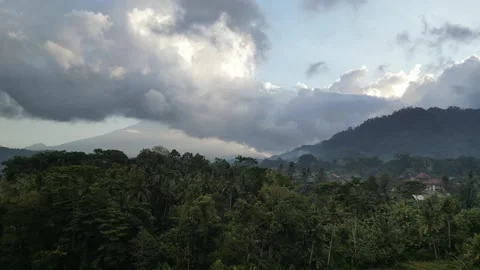 Aerial Drone Flying Forward Over Traditional Village in Bali and Sacred Mountain Video stock 332463105