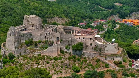 Aerial: drone flying at old medieval abbey perched on mountain top,  Stock Footage 254810560