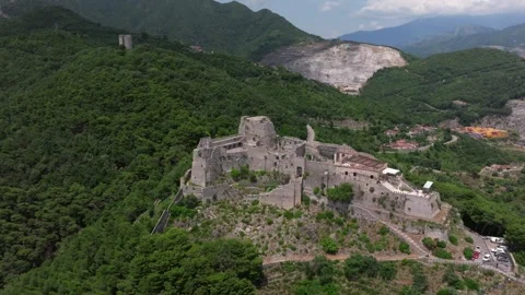 Aerial: drone flying at old medieval abbey perched on mountain top, at sunrise Stock Footage 280123284