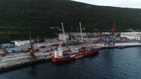 Aerial. Drone flying over a container ship and ship's automatic loaders Video stock 140032608