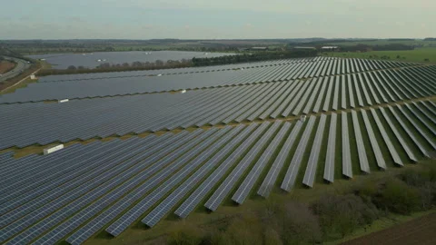 Aerial drone flying over fields of solar panels at farm Stock Footage 236012095