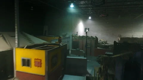 Aerial: Drone Flying Over Objects And Props Amidst Cottages With Military Tank Video stock 249302975