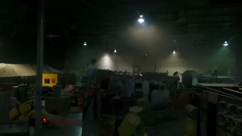 Aerial: Drone Flying Over Objects And Props Amidst Cottages At Illuminated Film Video stock 249334442