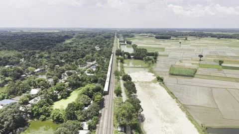 Aerial drone flying over passenger train traveling through rural railway Stock Footage 344544270