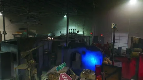 Aerial: Drone Flying Over Props And Objects Amidst Cottages At Illuminated Film Video stock 249304468