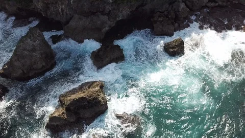 Aerial - Drone flying over waves crashing on rocks - Siargao - The Philippines Video stock 92347585
