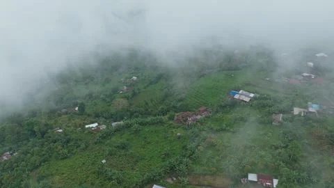 Aerial drone flying through clouds over munduk village in bali Stock Footage 328914428