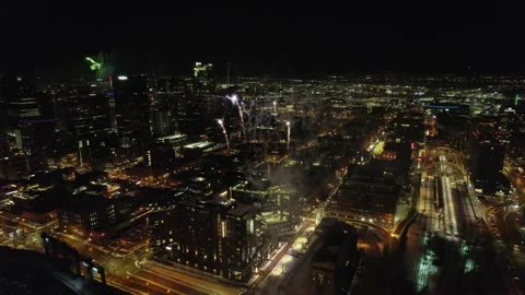 Aerial Drone Flying Through Exploding Fireworks Show Over Downtown City Stock Footage 231868514