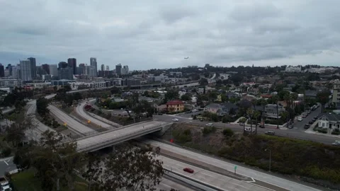 Aerial drone flying toward Interstate 94 in San Diego at 7PM during sunset as Stock Footage 333280139