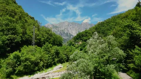 Aerial Drone Flying Toward Mountain Valley and River in Tuscany Italy Summer  Stock Footage 329054444