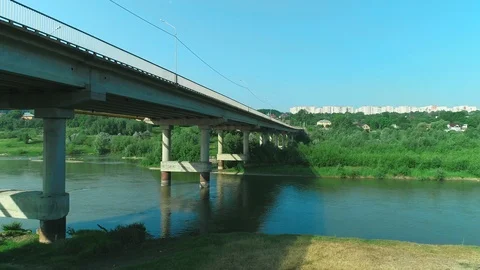 Aerial drone is flying under the bridge with trafficing over. 4K. Stock Footage 113291005