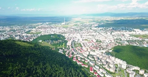 Aerial Drone Flyover Carpathian Mountains And Brasov City Stock Footage