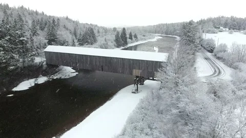 Aerial Drone flyover of a Covered Bridge on a Snowy WInter's Day Stock Footage 172423835