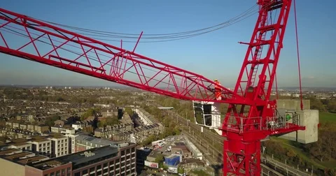 Aerial drone footage of construction workers on a tower crane. Vídeos de archivo 82324757