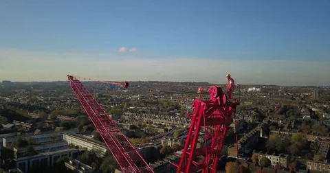 Aerial drone footage of construction workers on a tower crane. Vídeos de archivo 82326729