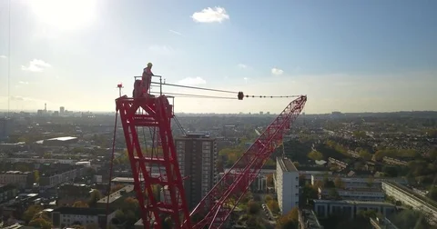 Aerial drone footage of construction workers on a tower crane. Vidéo 82329083