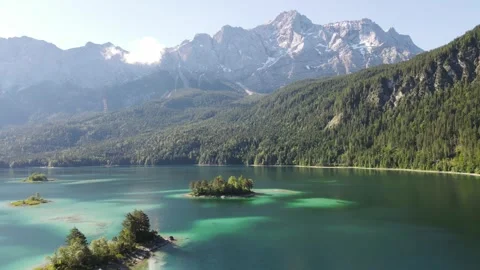 Aerial drone footage of Eibsee alpine lake with Zugspitze mountain, turquoise Stock Footage 328347008