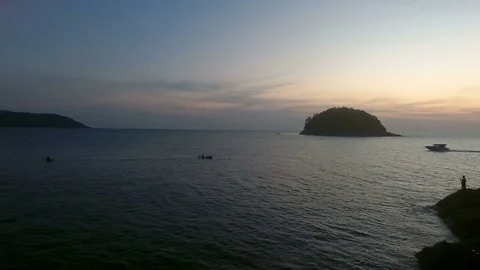 Aerial drone footage of flight above calm water, near wild island and yacht Stock Footage