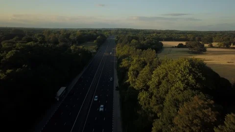 Aerial drone footage flying forwards over a highway through the countryside. 動画素材 91237894