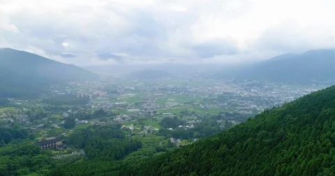 Aerial Drone Footage Flying over Yufuin city with Mount Yufu Below Stock Footage