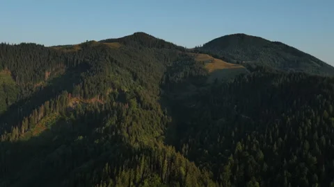 Aerial drone footage of green fields in morning mountains during sunrise Stock Footage 160148671