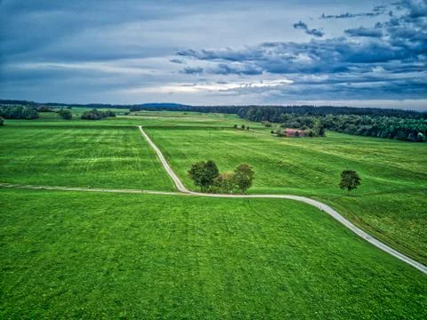 Aerial Drone Footage HDR with Sky and Tree in a Field, small gravel Road Stock Photos