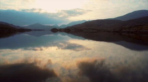 Aerial Drone footage of lake and mountains against sky Stock Footage