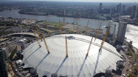 Aerial drone footage of the O2 stadium in London, England on a sunny day. Stock Footage
