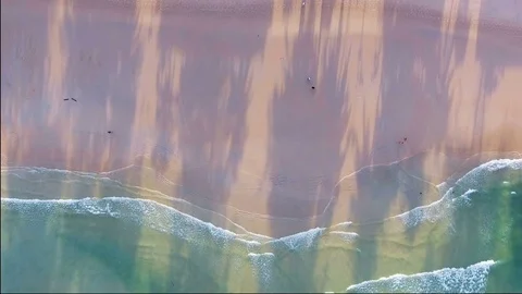 Aerial drone footage of ocean waves reaching shore Видео 80853090