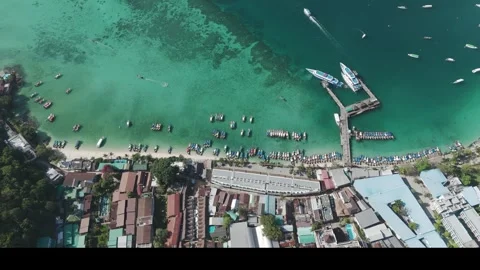 Aerial Drone Footage of Phi Phi Island Harbor with Boats and Coastal Buildings Stock Footage 314303433