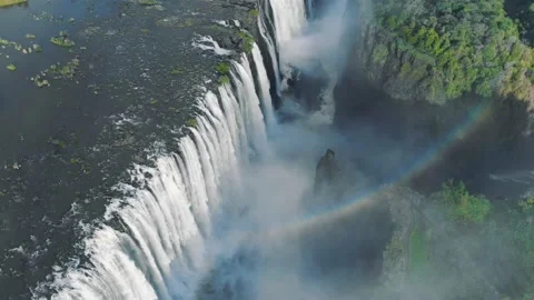 Aerial drone footage of rainbow in Victoria Falls between Zambia and Zimbabwe Stock Footage