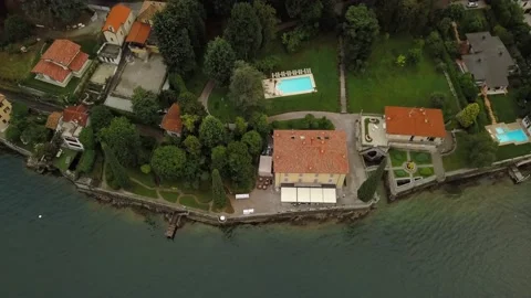 Aerial drone footage of small villa on lake Como. Lombardy, Italy. Top View. Stock Footage