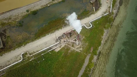 Aerial drone footage of smoke stack billowing a cloud of gas at a plant. Stock Footage 94706825