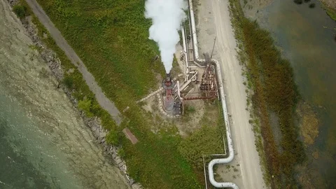 Aerial drone footage of smoke stack billowing a cloud of gas at a plant. Stock Footage 94706858