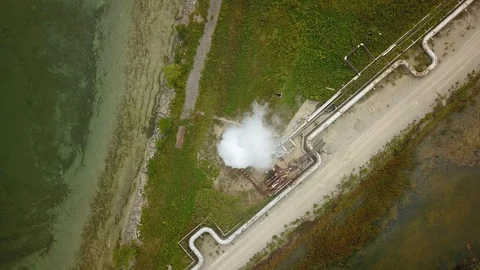 Aerial drone footage of smoke stack billowing a cloud of gas at a plant. Stock Footage 94706899