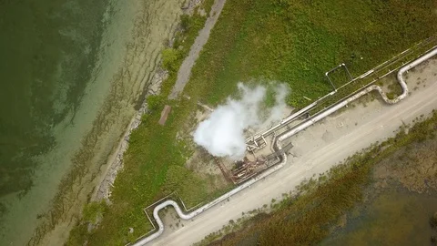 Aerial drone footage of smoke stack billowing a cloud of gas at a plant. Stock-Footage 94706932